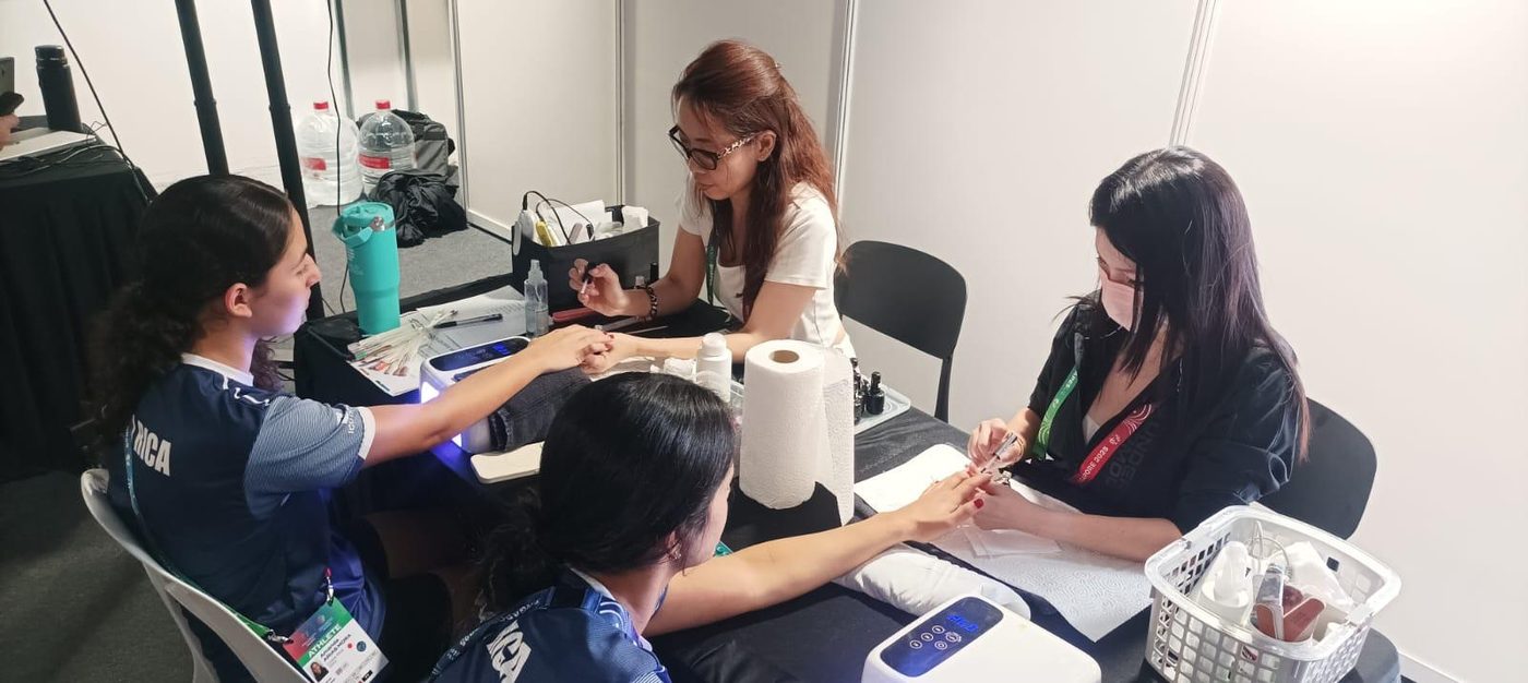 Passionate Nails artist giving an athlete a manicure at the World Aquatics Championships Singapore 2025