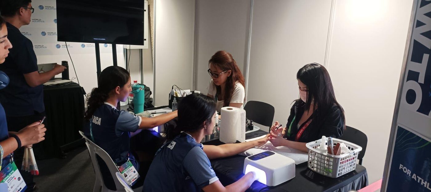 Passionate Nails manicure booth serving athletes at the World Aquatics Championships
