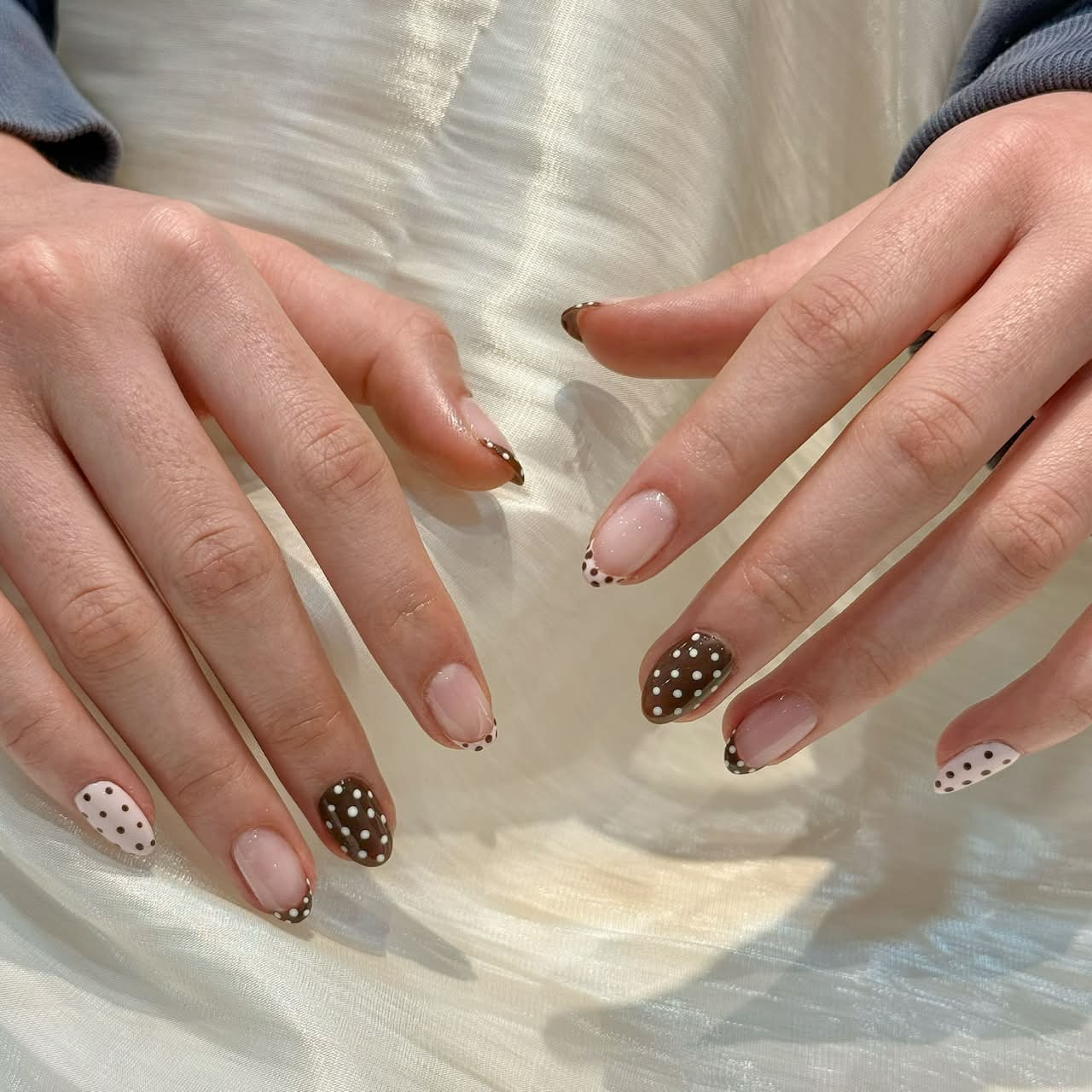 Brown polka-dot French almond nails