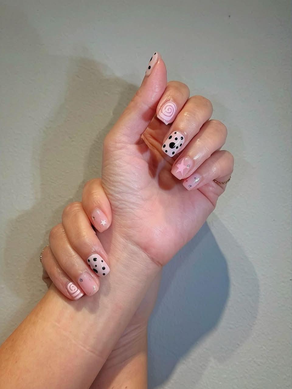 Pink nails with swirl, polka-dot and star art